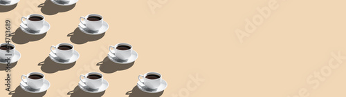 Set of coffee cups on saucer isolated on beige background seamless pattern with copy space