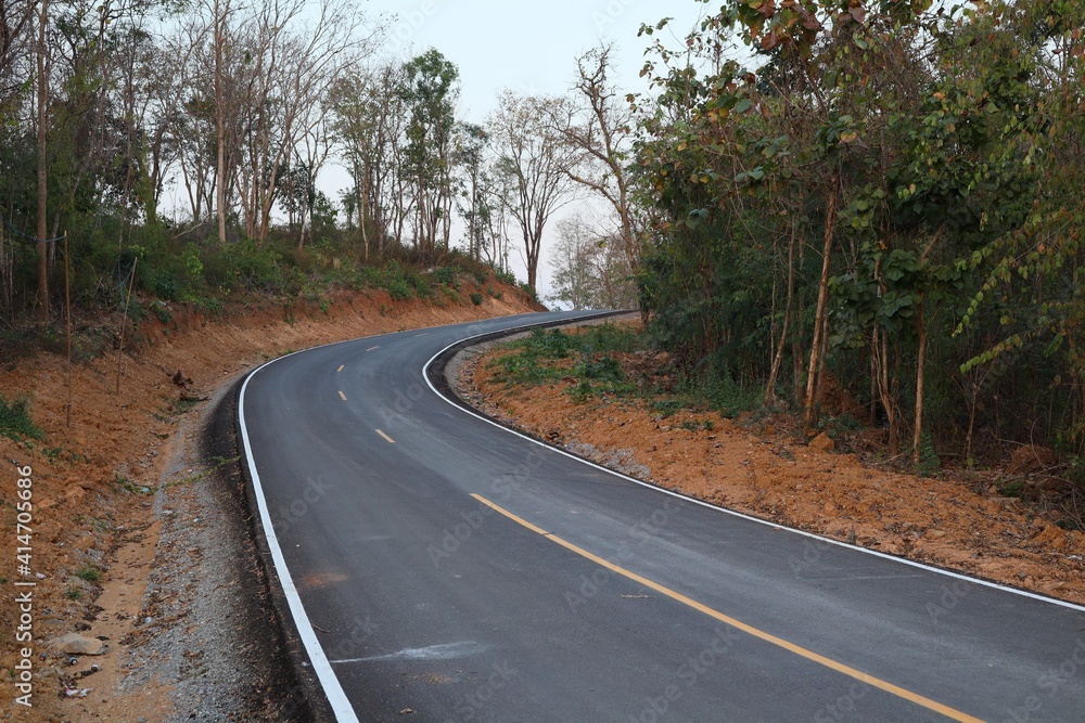 Empty road, hills in the forest through the green trees Photos outside Uttaradit City, Thailand