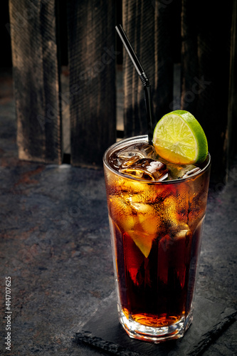 Bild auf Leinwand Classic Cuba Libre cocktail with brown rum, cola and lime, long drink at the Cub
