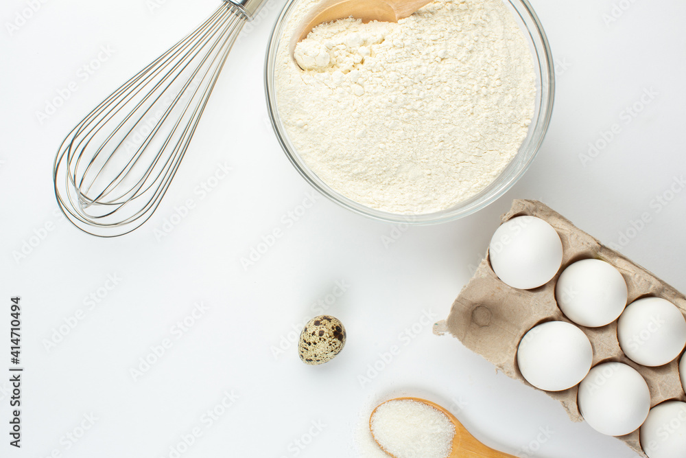 Eggs and quail eggs and sugar, coconut shavings in wooden spoons Eggs and quail eggs and sugar, coconut shavings in wooden spoons