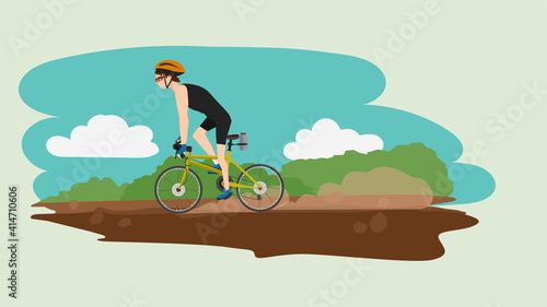 Male athlete throws a bicycle at a speed on an dirt road. Dust scattered behind a lot. Background image of green grass and blue sky.