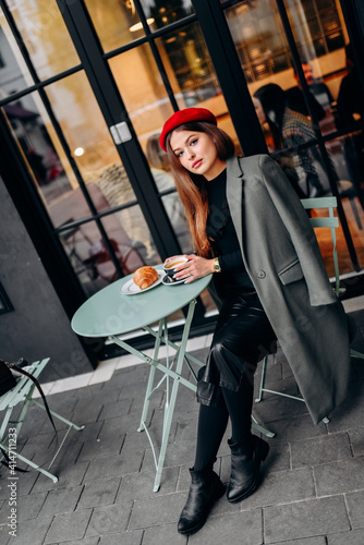 Girl drinking coffee in the cafe. © dmytro_khlystun