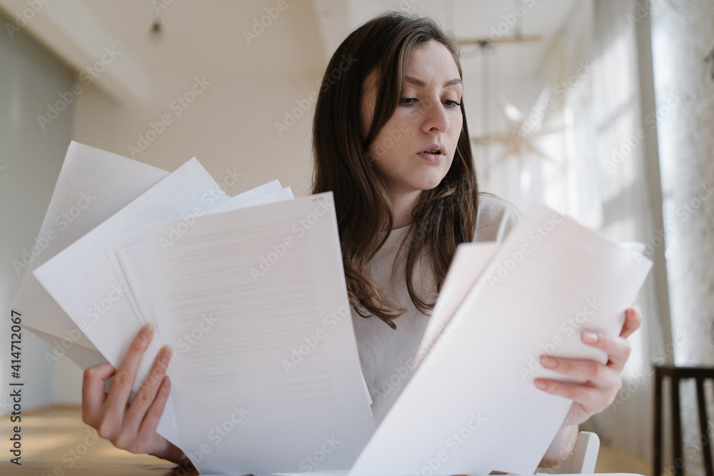 Overload with paperwork. Employed worker on the remote work at home Overload with paperwork. Employed worker on the remote work at home