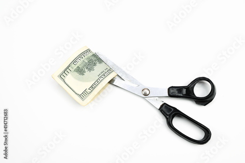 Scissors cut the dollar, on an isolated white background