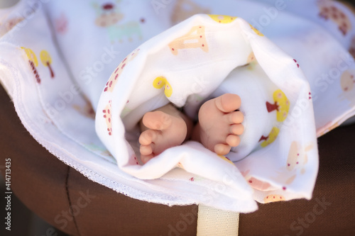 Newborn baby feet, barefoot with tiny toes in selective focus, family and maternity concept. Photo of newborn baby feet.