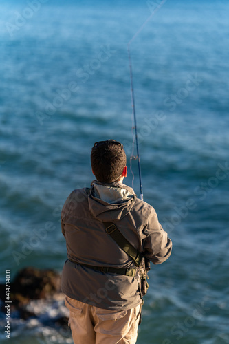 fisherman with fishing clothes and equipment at sea