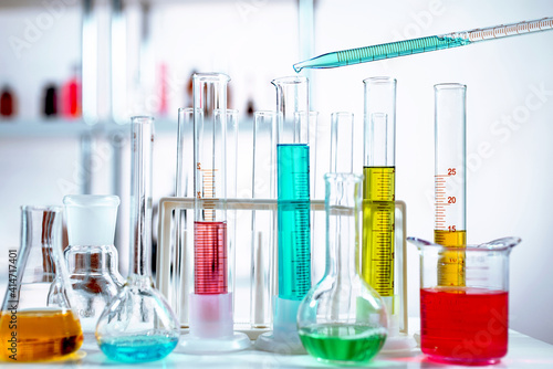 Manipulating pipette with liquid. Chemical laboratory