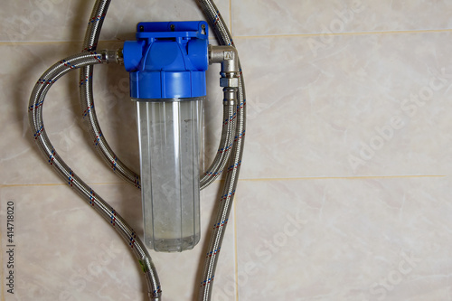 Close-up view of a compact water softening and filtration system. Universal home water softening system.