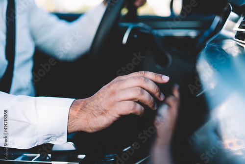 Anonymous man adjusting settings in car