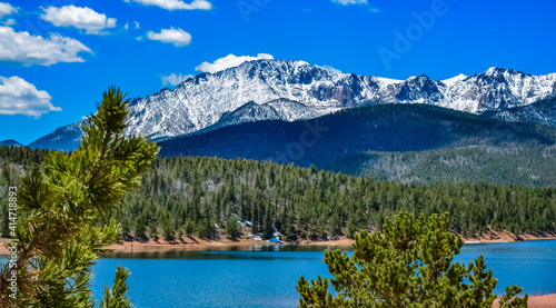 Panorama Snow-capped and forested mountains near a mountain lake, Pikes Peak Mountains in Colorado Spring, Colorado, US