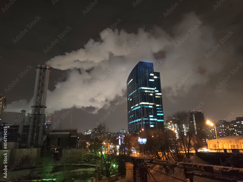 Night city skyscraper, urban cityscape with modern buildings and smoke wallpaper