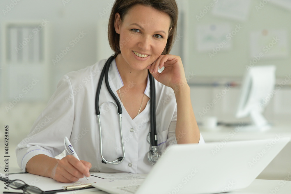 Portrait of female doctor in hospital with laptop
