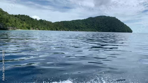 Turquoise Sea And Green Tropical Trees In Triton Bay In Kaimana Islands. Wide Angle Of Wild Nature: Pacific Lagoon And Beautiful Landscape In Papua, Indonesia. photo