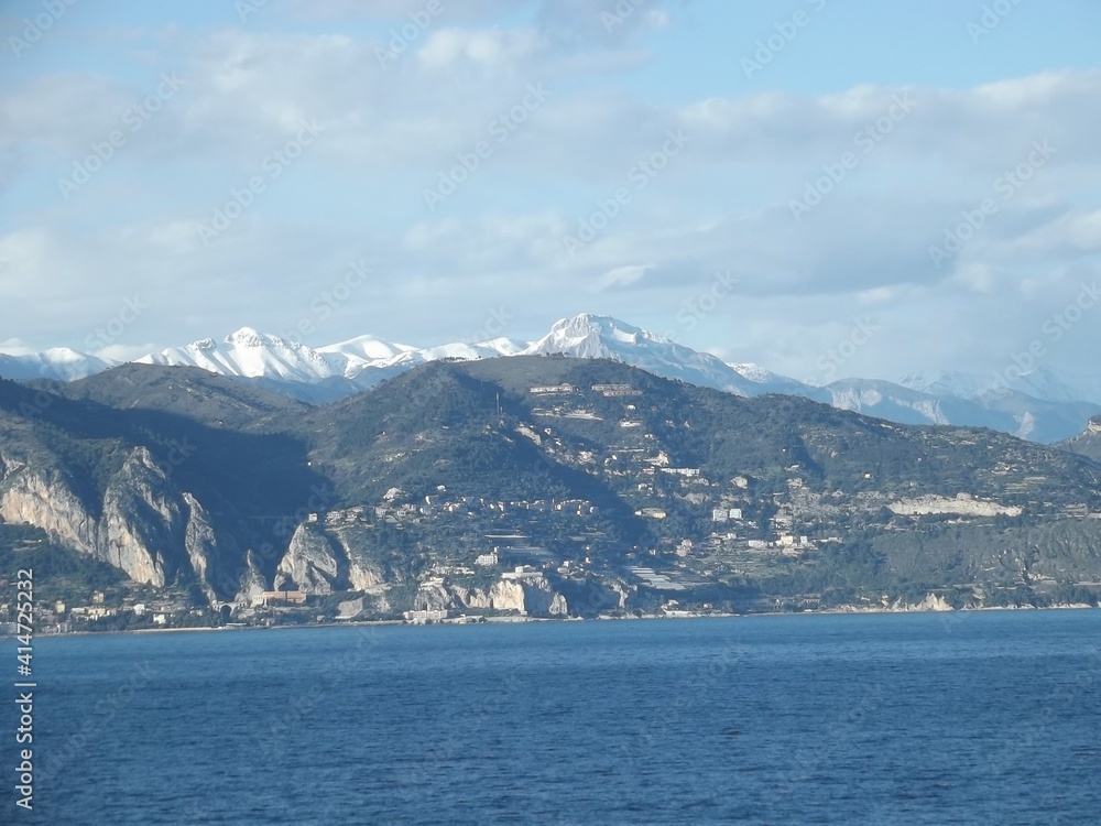 view towards the cote d’azur with the snow capped mediterranean alps in the background, france