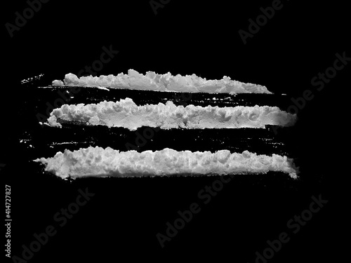 Cocaine drug powder lines on black background