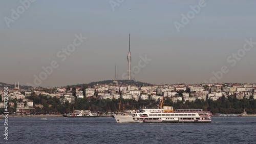 Local ships and ferries passing through the bosporus in the background Camlica TV tower and Istanbul's Asian side neighborhood names Salacak Harem Uskudar photo