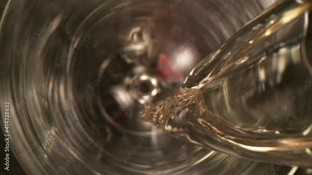 Super slow motion of pouring white wine into glass with camera motion. Filmed on high speed cinema camera, 1000 fps. Super slow motion of pouring white wine into glass with camera motion. Filmed on high speed cinema camera, 1000 fps.
