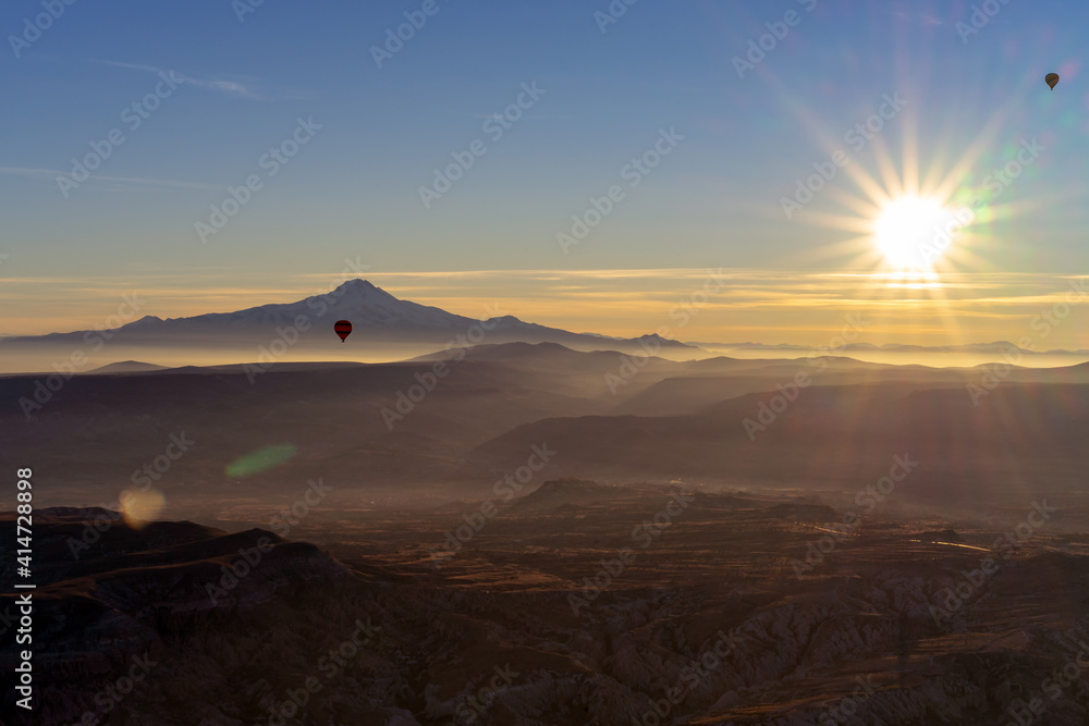 Hot Air balloons flying tour over mountains landscape beautiful sunrise Cappadocia, Goreme, Unesco world heritage