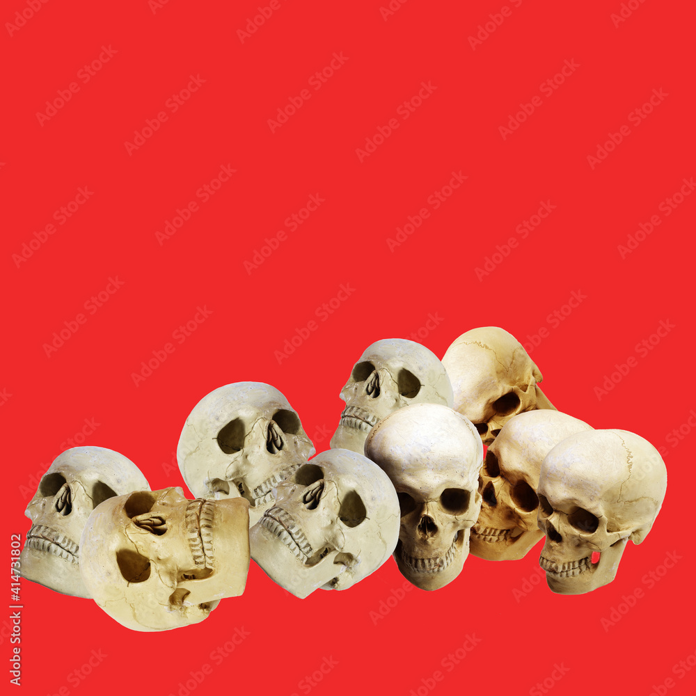 Several human skulls on a red background.Symbol of war, epidemic, death. Several human skulls on a red background.Symbol of war, epidemic, death.