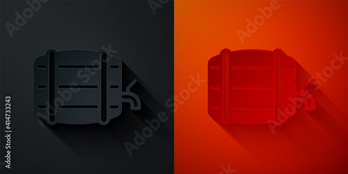 Paper cut Wooden barrel on rack with stopcock icon isolated on black and red background. Paper art style. Vector.