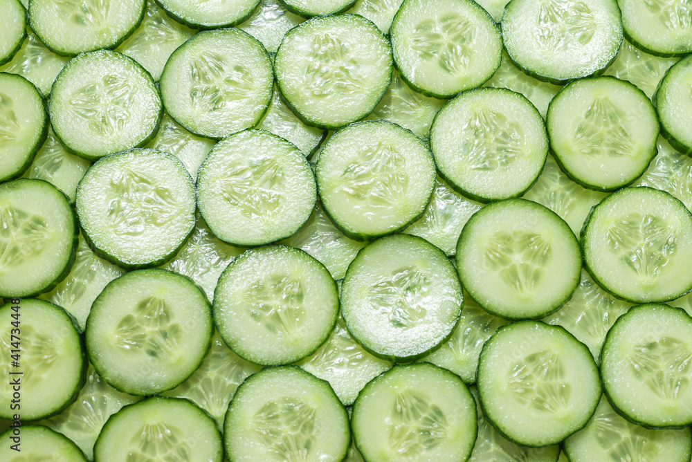 Fresh green slices of cucumber as background. Fresh green slices of cucumber as background.