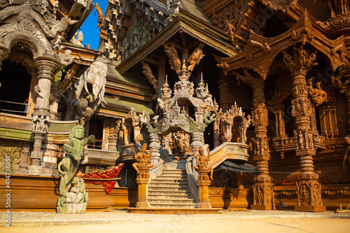 Wooden Temple in Pattaya. Traveling in Thailand. Wooden sculptures of beautiful carved patterns on the roof.