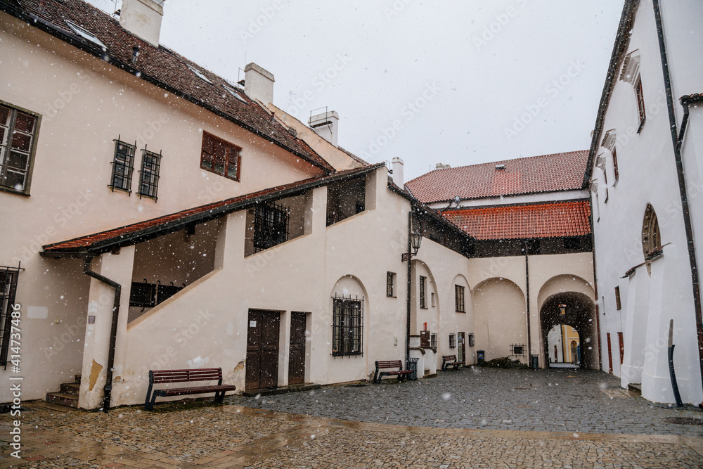 Renaissance courtyard, Baroque medieval castle with stone gothic tower, historical building on the Otava, snow in winter day, Strakonice, Southern Bohemian region, Czech Republic