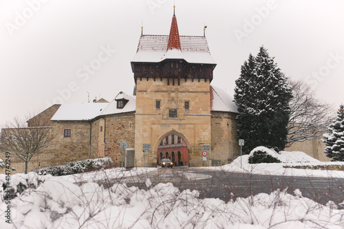 Old town gate, Zatec Gate in Louny town, Czech Republic. Louny city in Czechia north region in winter. Medieval fortification stone walls and gate. 
