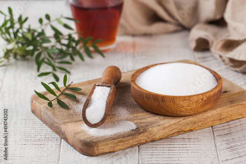 Natural sweetener in a wooden spoon. Sugar substitute. Erythritol photo