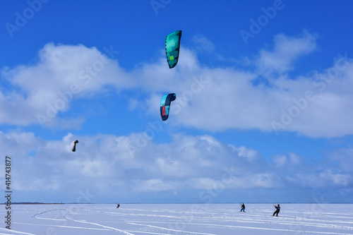 Kitesurfing in winter on ice. The Vistula Lagoon in Poland, a beautiful landscape.	
