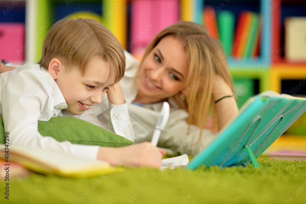 Mother with her son doing homework at home Mother with her son doing homework at home