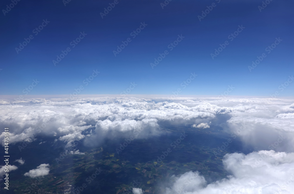 Beautiful sky landscape with view from the aircraft above dense white clouds high in the stratosphere on a sunny day horizontal photo Beautiful sky landscape with view from the aircraft above dense white clouds high in the stratosphere on a sunny day horizontal photo