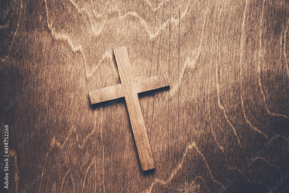 wooden cross on the wooden table