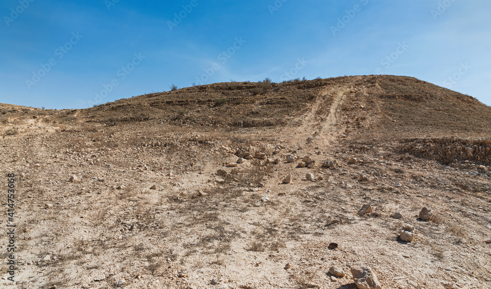 illegal off road track causing permanent damage in a protected nature reserve near the Makhtesh Ramon crater in Israel with a blue sky background illegal off road track causing permanent damage in a protected nature reserve near the Makhtesh Ramon crater in Israel with a blue sky background