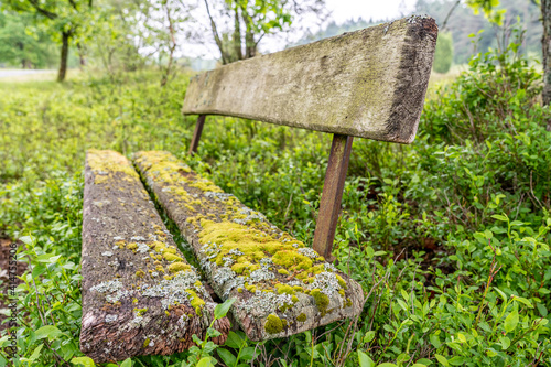 old wooden bench in the hillside landscape in the nature preservation area of the lueneburger heide photo