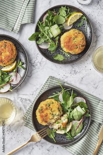 Quadro em tela Smoked mackerel fishcakes served with a rocket, spinach salad