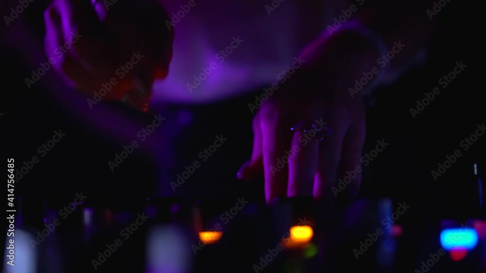 Close-Up of female hand plays music with dj mixer panel in night club. Footage. Close-Up of female hand plays music with dj mixer panel in night club. Footage.