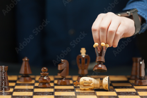 Bild auf Leinwand The hand of the young grandmaster makes a move by the queen overthrow the oppone