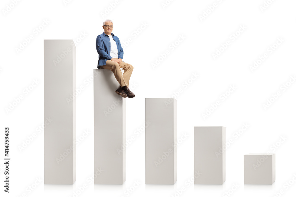 Smiling mature man sitting on a graph chart and looking at camera Smiling mature man sitting on a graph chart and looking at camera