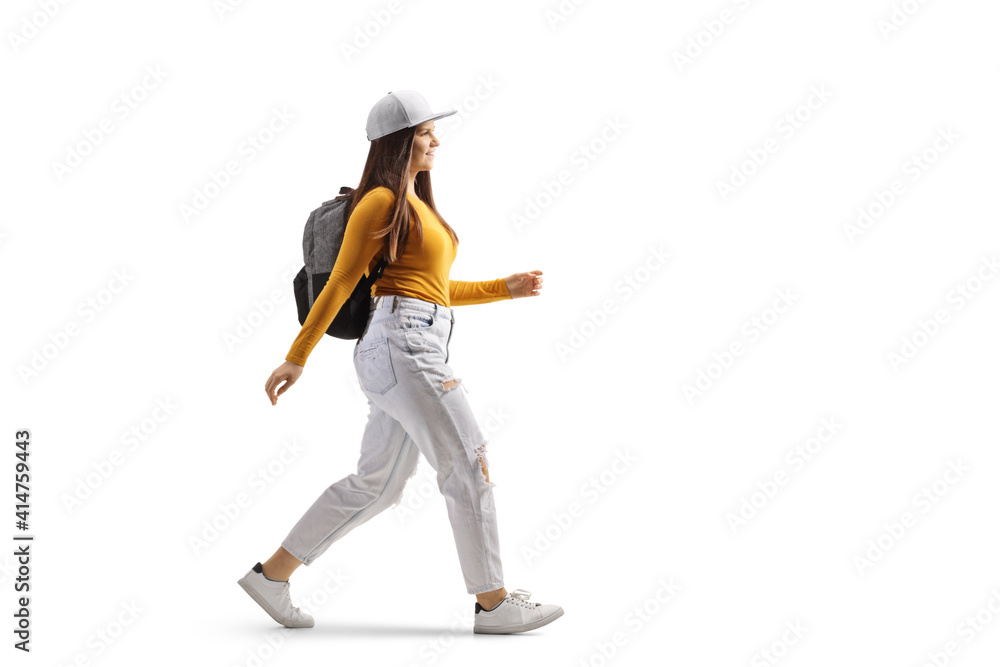 Full length profile shot of a cheerful female student walking