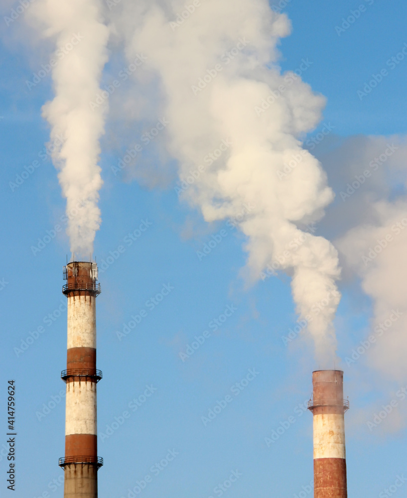 smoke from a chimney against a blue sky.