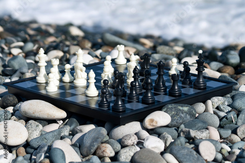 Chess board with chessmen on the beach