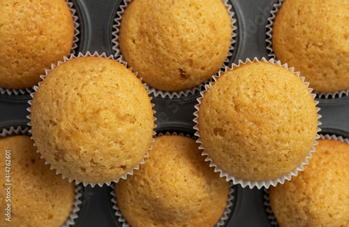 flatley muffins made from white flour, freshly baked. Lie in a baking dish. pattern of cupcakes. confectionery texture concept. High quality photo photo