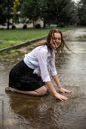 Fototapeta Naklejka Na Ścianę i Meble -  girl dancing in the rain