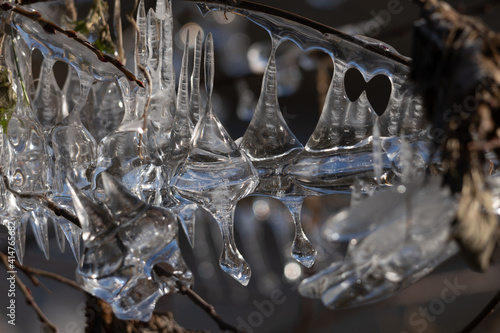 Light reflected through icicles at a river in winter time