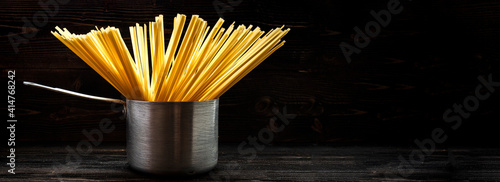 spagetti or spaghetti or noodle in brushed metal stewpot utensil photo