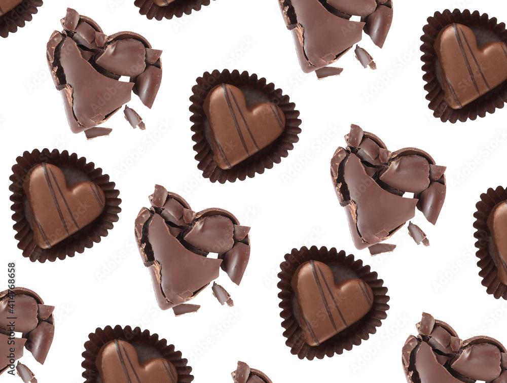 Set with delicious heart shaped chocolate candies on white background, top view Set with delicious heart shaped chocolate candies on white background, top view