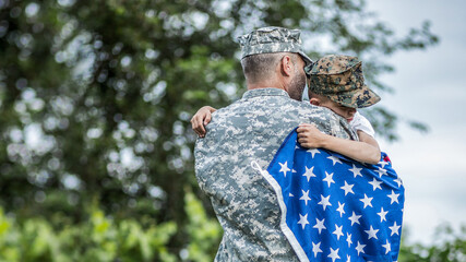 Happy reunion of soldier with family outdoors