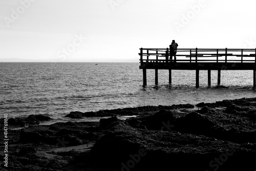 Couple kissing on Old wooden pier on the shore