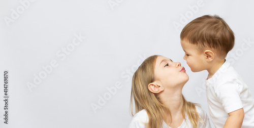 beautiful brother and sister kiss with copy space banner